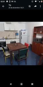 a kitchen with a table and chairs and a refrigerator at DEPTO Familiar in Gualeguaychú