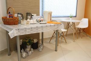 a kitchen counter with a table with food on it at Big Orange Hotel Sungai Petani in Sungai Petani