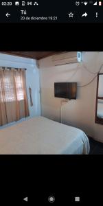 a picture of a bedroom with a bed and a window at DEPTO FAMILIAR dolar billete dolar blue in Gualeguaychú