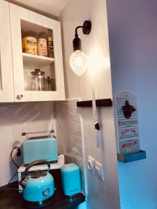 a kitchen with a counter with blue appliances in it at Cosy nest from 10 minutes PARIS centre in Saint-Ouen