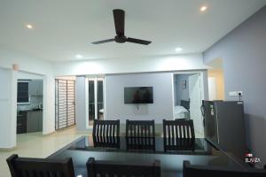 a dining room and living room with a ceiling fan at EMFORE ELANZA in Kottayam