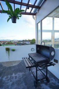 a barbecue grill sitting on top of a balcony at Grow home -Stay and space, Self check-in in Chiang Rai