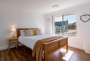 a bedroom with a large bed and a window at Rileystone in Margaret River Town