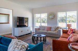 a living room with two couches and a tv at Rileystone in Margaret River Town