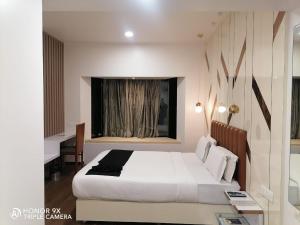 Postel nebo postele na pokoji v ubytování Orbett Hotel