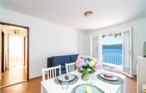 a dining room with a table and a view of the ocean at Gorgeous Home In Slano With House Sea View in Slano