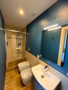 a bathroom with a sink and a toilet and a mirror at Guest House Le Contesse in Florence