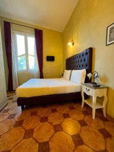 a hotel room with a bed and a table at Guest House Le Contesse in Florence