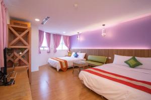 Una cama o camas en una habitación de Kenting Shin Yu Homestay