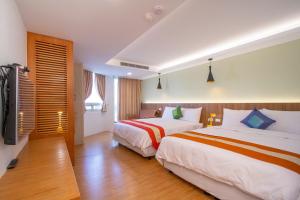 Una cama o camas en una habitación de Kenting Shin Yu Homestay