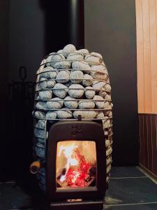 a large stack of rocks sitting on top of a fireplace at Hakuba Aurora Chalet by Jade Group in Hakuba