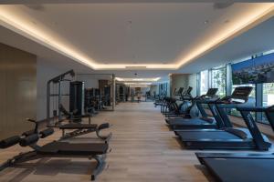 a gym with a row of treadmills and machines at STAY BY LATINEM Luxury 1BR Holiday Home OPA 802 near Burj Khalifa in Dubai