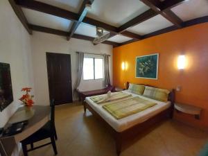 a bedroom with a large bed and a table in it at Malapascua Garden Resort in Malapascua Island