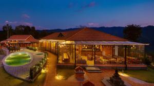 a large building with a swimming pool in front of it at Soaltee Westend Resort Nagarkot in Nagarkot
