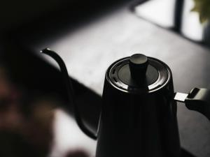 a black coffee maker sitting on a table at Minamo in Ukiha