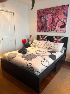 a bedroom with a bed with a hello kitty painting at Prospect House in London