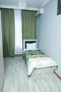 a bedroom with a bed and a window at RamRamay in Qax