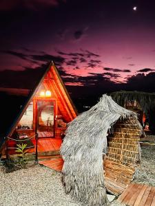 a small house with a thatch roof on a beach at Hotel Luna Azul Tatacoa in Villavieja