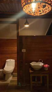 a bathroom with a toilet and a sink at Hotel Luna Azul Tatacoa in Villavieja