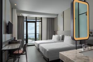 Postel nebo postele na pokoji v ubytování Hotel Santika Premiere Padang