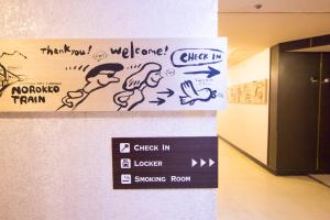 a sign in a room with graffiti on a wall at SEVEN Building / Vacation STAY 4943 in Asahikawa