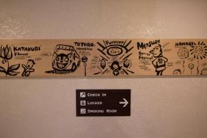 a sign on the top of a refrigerator covered in graffiti at SEVEN Building / Vacation STAY 4961 in Asahikawa