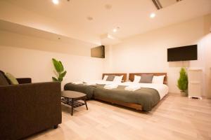 a bedroom with a large bed and a tv at SEVEN Building / Vacation STAY 4959 in Asahikawa