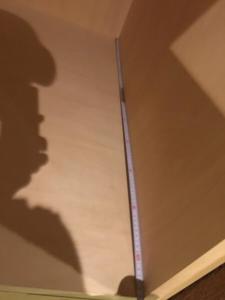 a ruler on a ceiling with a shadow of a man at SEVEN Building / Vacation STAY 4953 in Asahikawa