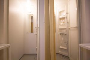 a bathroom with a white door and a washer at SEVEN Building / Vacation STAY 4952 in Asahikawa