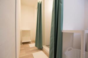 a room with green curtains and a wooden floor at SEVEN Building / Vacation STAY 4940 in Asahikawa