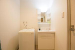 a small bathroom with a refrigerator and a sink at SEVEN Building / Vacation STAY 4940 in Asahikawa