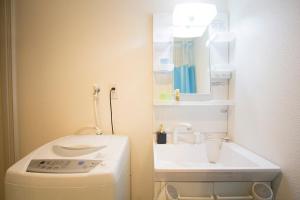a small bathroom with a sink and a washing machine at SEVEN Building / Vacation STAY 4951 in Asahikawa