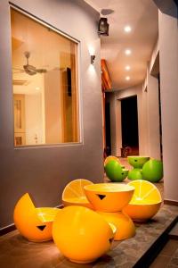 a room with yellow and green chairs and a mirror at Big Orange Hotel Sungai Petani in Sungai Petani
