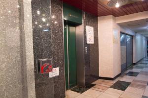 korytarz budynku ze znakami na ścianie w obiekcie SEVEN Building / Vacation STAY 4948 w mieście Asahikawa