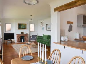 a living room with a green couch and a table at Seaways in Lee-on-the-Solent