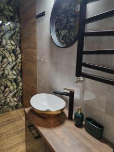 een badkamer met een wastafel op een houten aanrecht bij Apartament Loft KB-Ściegiennego (garaż, centrum) in Kielce +28 foto's
