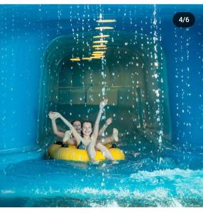 two young children riding on an inner tube in the water at Ferienwohnung BERGLIEBE in Nesselwang