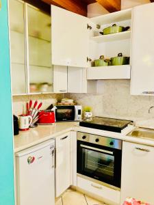 A kitchen or kitchenette at Central Apartment Private Parking Terrace & AC
