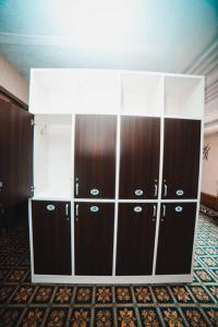 a large closet with brown and white cabinets at Capsule hotel TechnoCave in Bishkek