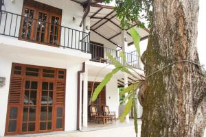 an external view of a house with a tree at Sanmi Airport Resort in Katunayaka