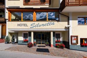 a hotel with a sign on the front of a building at Hotel Silvretta in Kappl