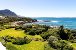an aerial view of a golf course with the ocean at Bayview 305A in Hermanus