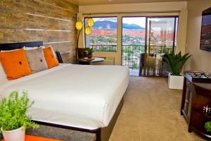 a hotel room with a large bed and a large window at Inn On The Cliff in St. George
