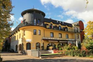 a large yellow building with a water tower on top of it at B & B Tomula in Gdańsk