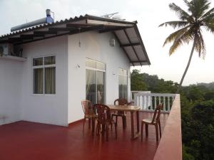 a patio with chairs and a table on a house at Mount View Villa Resort Mirissa in Mirissa