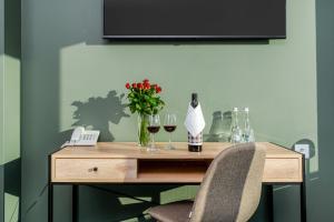 a table with two wine glasses and a bottle of wine at Hotel Artur in Krakow