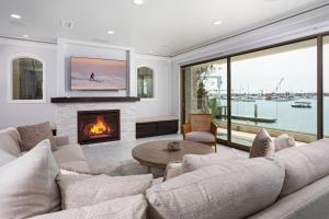 a living room with a couch and a fireplace at 367 Via Lido Soud home in Newport Beach