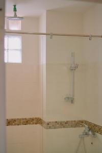 a shower with a glass door in a bathroom at Anh Truc House - Near Front Beach in Vung Tau