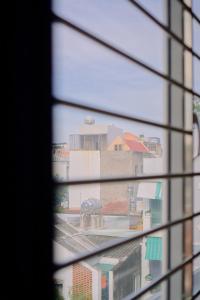 a view of a building through a window at Anh Truc House - Near Front Beach in Vung Tau