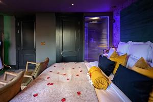 a bedroom with a bed with red hearts on it at The Bells - Luxury Serviced Apartments in Leeds